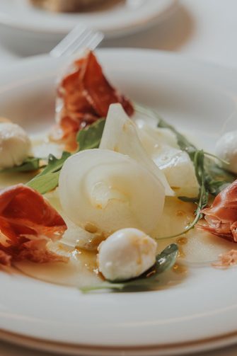 Plato con el carpaccio de melón acompañado de otras delicias